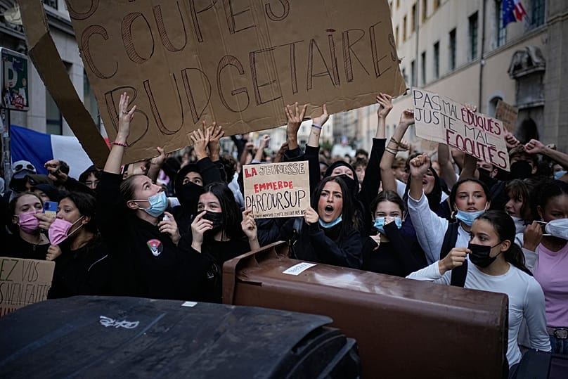 Students hold a sign reading "Stop budget cuts" as they protest against under-resourced schools in Lyon, 2 October, 2026