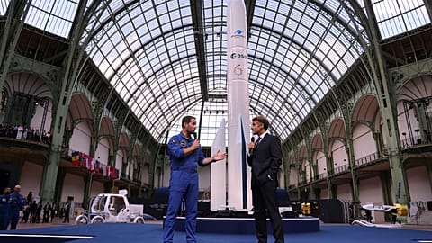 French European Space Agency astronaut Thomas Pesquet, left, and French President Emmanuel Macron speak during the International Space Summit at the Grand Palais in Paris.