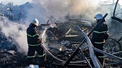 A rescue worker extinguishes a fire at a residential house destroyed by a Russian airstrike in Kharkiv, Ukraine, Friday, 2 October 2026.