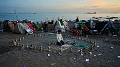 A migrant prays in the morning on El Trampolín beach in the Spanish enclave of Ceuta on Thursday, 1 October 2026.
