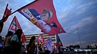 A campaign flag depicting Brazilian President Luiz Inacio Lula da Silva, who is running for reelection, is waved during a campaign event on streets in Brasilia, Brazil.