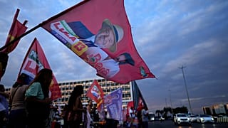 A campaign flag depicting Brazilian President Luiz Inacio Lula da Silva, who is running for reelection, is waved during a campaign event on streets in Brasilia, Brazil.