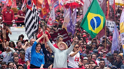President Luiz Inácio Lula da Silva, who is standing for re-election, waves the flags of Brazil and the state of São Paulo at a campaign rally