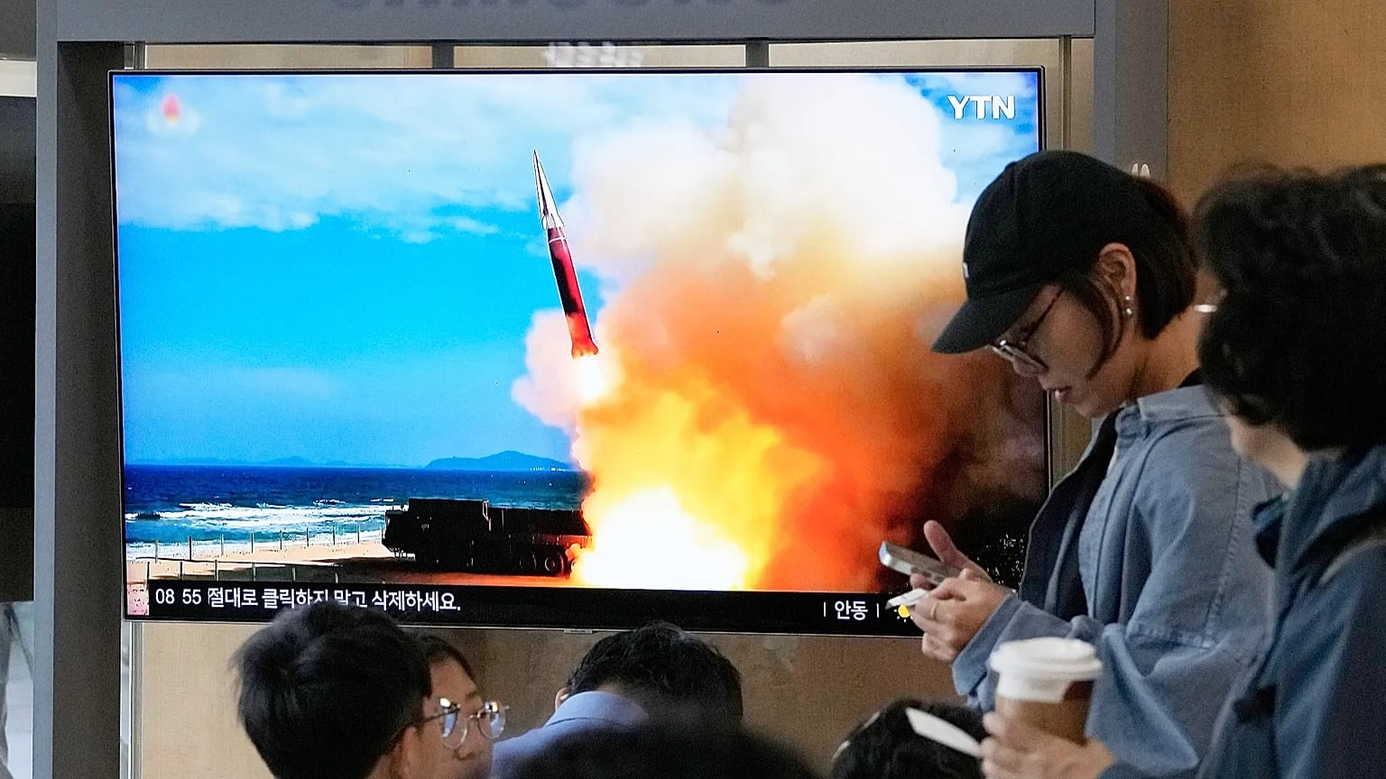 A TV screen shows a file image of a North Korean missile launch during a news program at Seoul Railway Station in Seoul, South Korea, Saturday, Oct. 3, 2026.