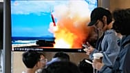 A TV screen shows a file image of a North Korean missile launch during a news program at Seoul Railway Station in Seoul, South Korea, Saturday, Oct. 3, 2026.