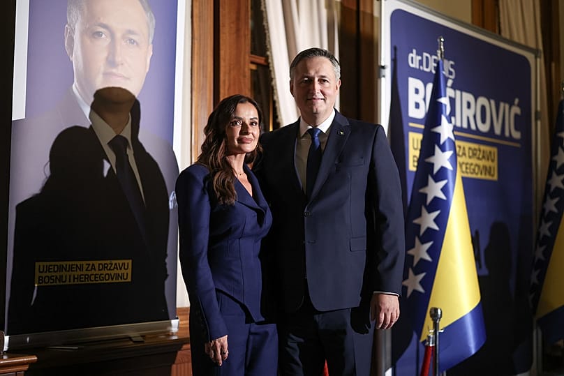 Denis Becirovic (SDP) poses for a photo with his wife after declaring himself winner of the Bosniak seat of the tripartite Bosnian Presidency in Sarajevo, Sunday, Oct. 4, 2026