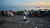 A migrant prays during the morning on El Trampolín Beach in the Spanish enclave of Ceuta Thursday, Oct. 1, 2026.