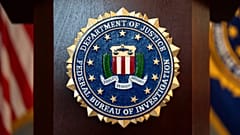 FILE - An FBI seal is displayed on a podium before a news conference at the field office in Portland, Oregon, Jan. 16, 2025