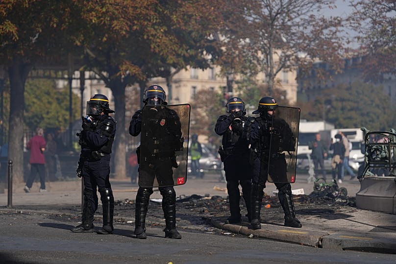 Policemen face students during a protest against under-resourced schools, in Paris, Friday, Oct. 2, 2026