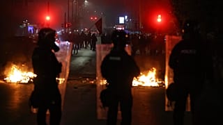 A protester line up opposite police units securing the entrance of the parliament building as protesters try to prevent Kosovo lawmakers from leaving.