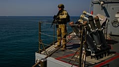 FILE: A Turkish army soldier stands guard on one of two ships sailing in the Mediterranean Sea, heading from the port of Mersin, Turkey, to the port of Beirut, 9 October 2024