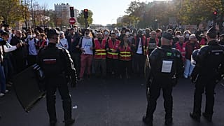 Riot police face union members and high school students as they gather before a demonstration against under-resourced schools in Paris, Tuesday, Oct. 6, 2026