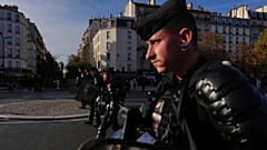 Riot police face high school students as they gather before a demonstration against under-resourced schools in Paris, Tuesday, Oct. 6, 2026.
