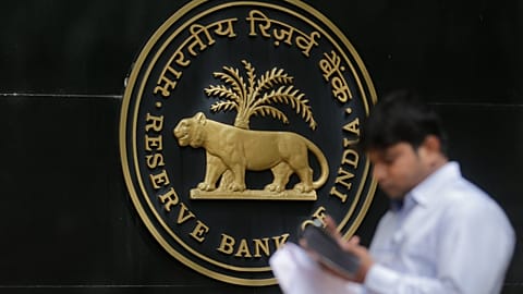 FILE. A journalist checks his cellphone outside the Reserve Bank of India (RBI) in Mumbai, 7 June 2017