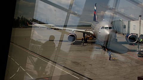 FILE: Through a window, an Aeroflot plane is seen parked for boarding next to a gate of Sheremetyevo airport outside Moscow, 9 July 2013