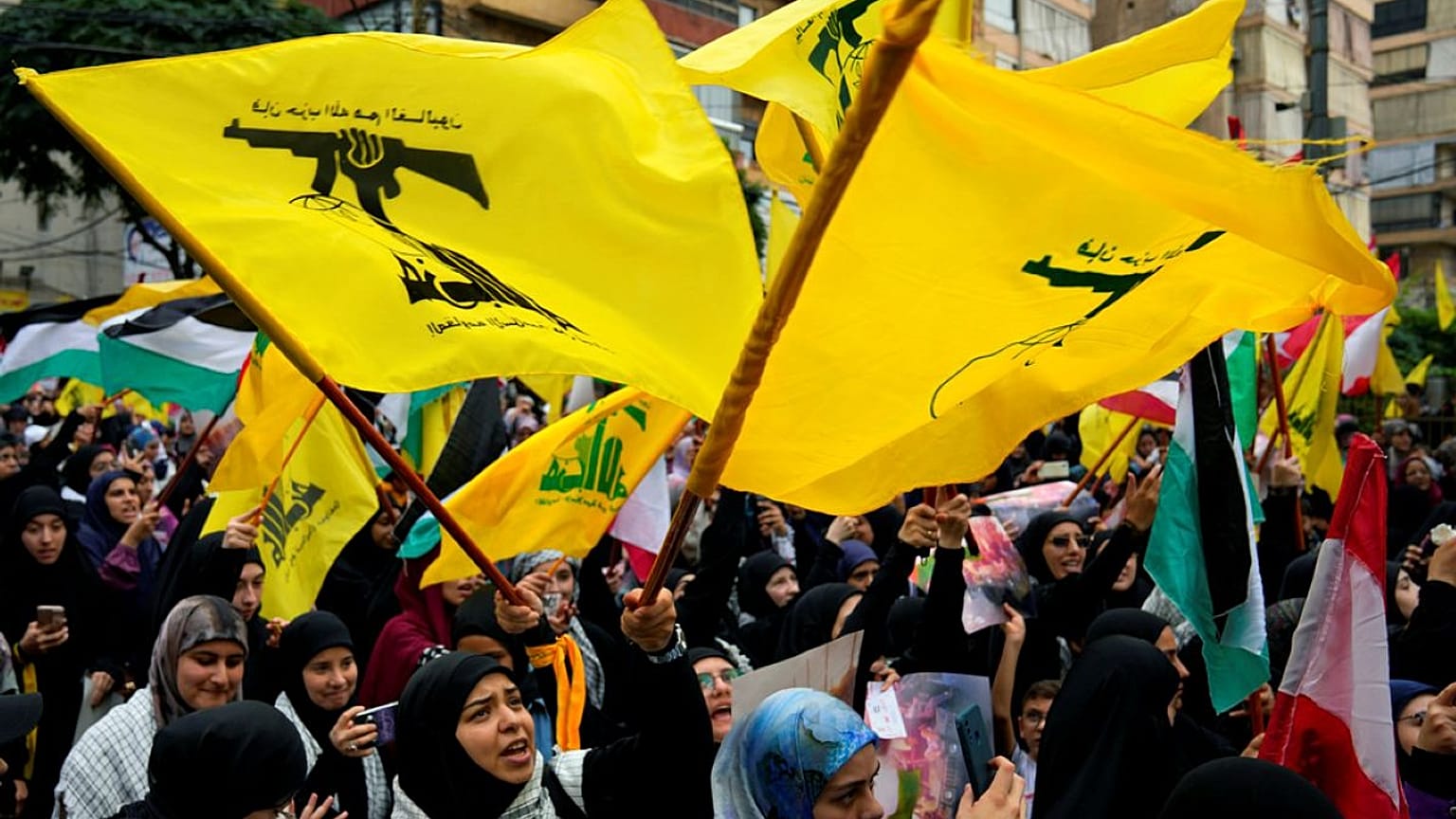 يلوح أنصار حزب الله بأعلام الجماعة، خلال مسيرة تضامنية مع الشعب الفلسطيني في غزة، وذلك في الضاحية الجنوبية لبيروت، لبنان، يوم الأحد 8 أكتوبر/تشرين الأول 2023. 