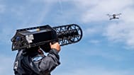 A police officer stands behind a drone with a "Counter LAV Jammer HP 47 + PR V7" during a demonstration as part of the opening of the drone defense center in in Erding, Germay