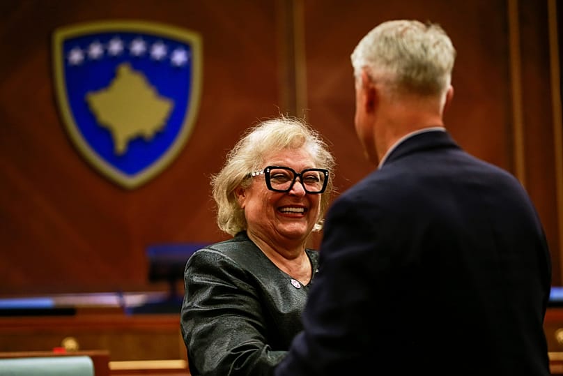 Kosovo lawmaker congratulates newly elected Kosovo's President Justina Shiroka Pula, center, in Kosovo's capital Pristina on Tuesday, Oct. 6, 2026