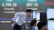 File - Traders watch monitors near a screen showing the KOSPI at the foreign exchange dealing room of the Hana Bank headquarters in Seoul, Thursday, 8 Oct. 2026. 