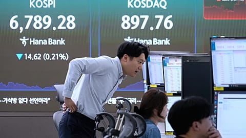 File - Traders watch monitors near a screen showing the KOSPI at the foreign exchange dealing room of the Hana Bank headquarters in Seoul, Thursday, 8 Oct. 2026. 