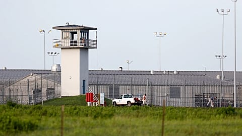 An inmate works outdoors during a hot summer day outside a Texas prison unit in Huntsville, Texas, on June 25, 2015.