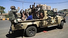 FILE: Houthi supporters chant slogans while riding in the back of a pickup truck at an armed tribal rally in Sanaa, 7 October 2026