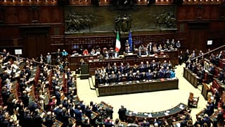 Italian Premier Giorgia Meloni, center, receives an applause as she addresses the lower Chamber ahead of a confidence vote for her Cabinet, Tuesday, Oct. 25, 2022