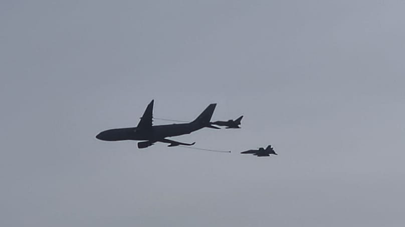 A330 air-to-air refuelling aircraft escorted by F18 jets.