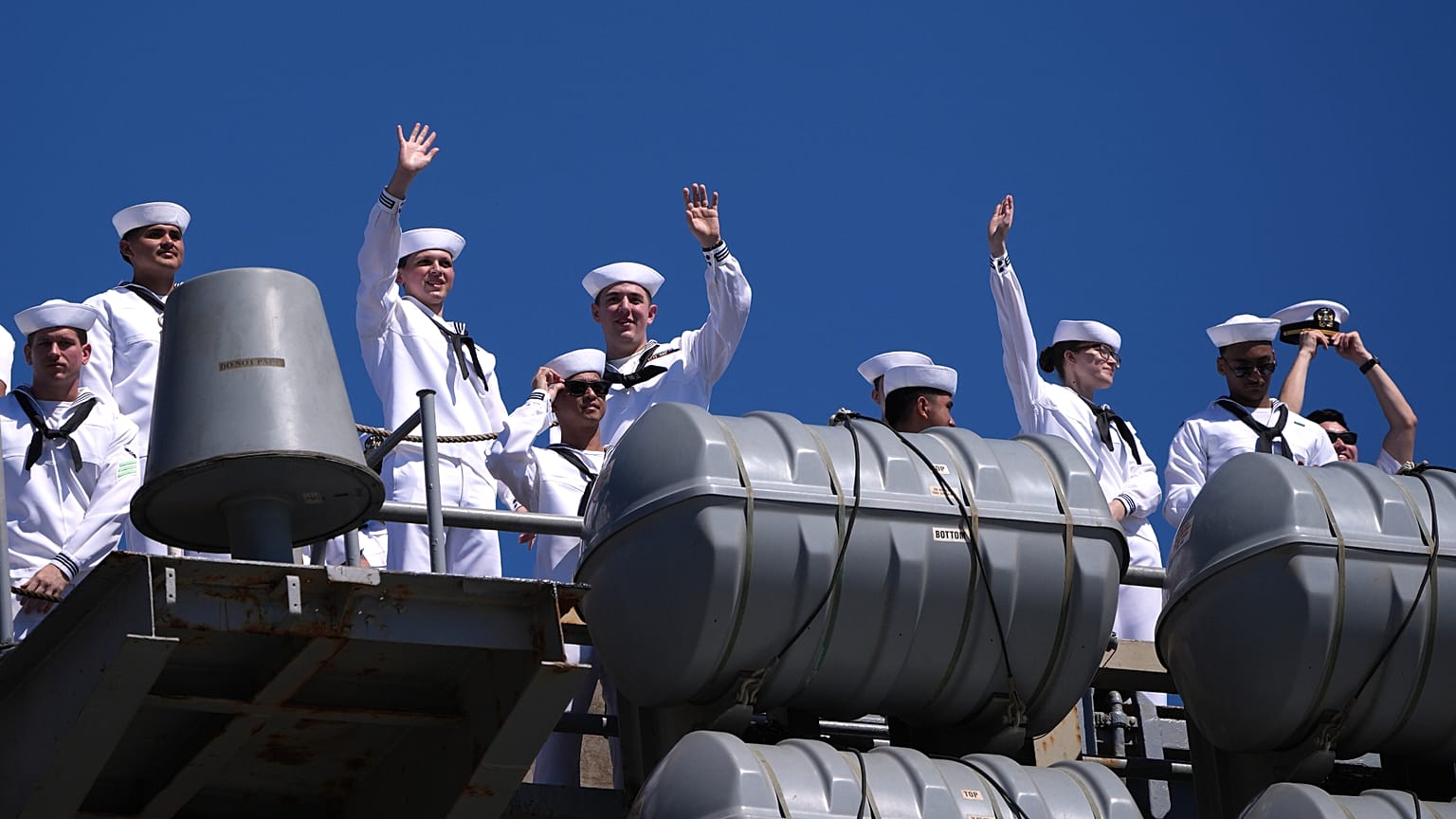 Sailors wave aboard the USS Abraham Lincoln aircraft carrier as it returns to Naval Air Station North Island after deployment Thursday, Oct. 8, 2026, in Coronado, Calif.