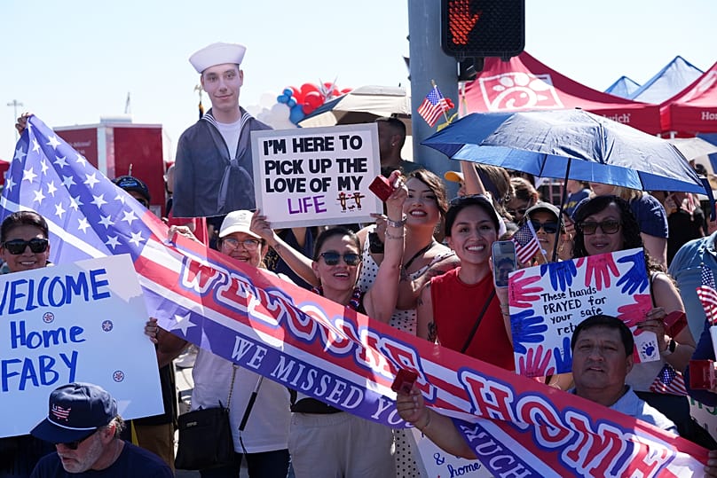 Family and friends wait to greet the USS Abraham Lincoln aircraft carrier as it returns to Naval Air Station North Island after deployment Thursday, Oct. 8, 2026, in Coronado,