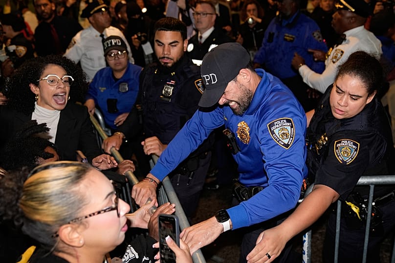 Protestors scuffle with police near at the scene of a shooting on Thursday, Oct. 8, 2026, in New York
