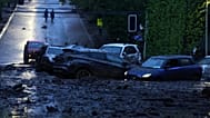 Vehicles are partially inundated in muddy floodwaters after heavy rains caused flash flooding in the Las Condes district of Santiago, Chile, Thursday, Oct. 8, 2026