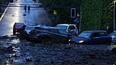 Vehicles are partially inundated in muddy floodwaters after heavy rains caused flash flooding in the Las Condes district of Santiago, Chile, Thursday, Oct. 8, 2026