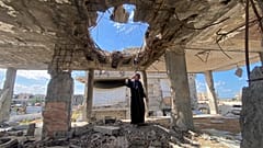 Maryam Abu Hazein, a Palestinian, on the rubble of her home in al-Mughraqa, west of Gaza City