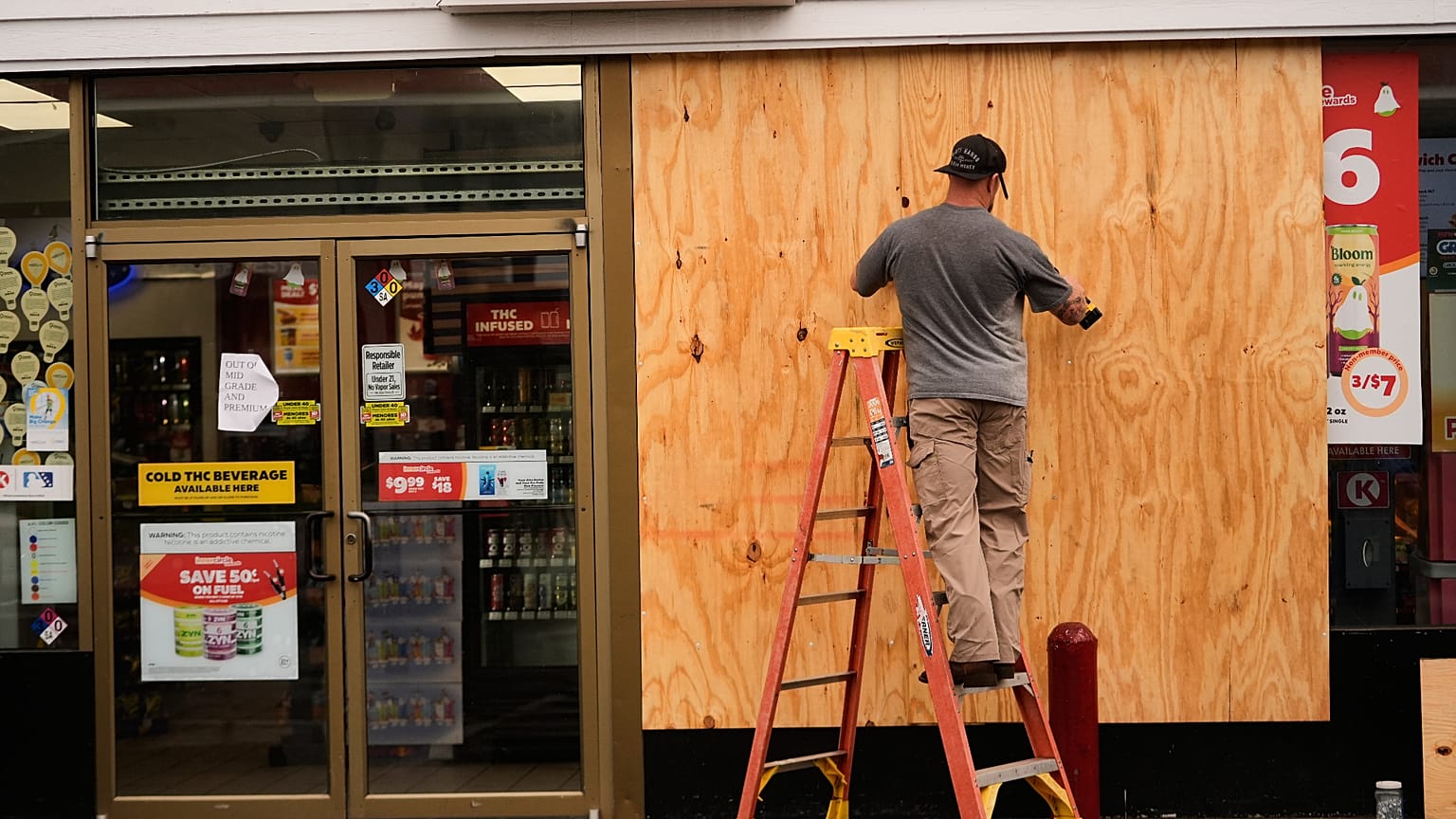 Jason Coffey boards up a convenience store at a gas station as Hurricane Isaias approaches Pensacola Beach, Fla., Friday, Oct. 9, 2026.