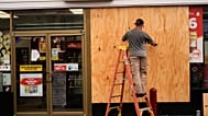 Jason Coffey boards up a convenience store at a gas station as Hurricane Isaias approaches Pensacola Beach, Fla., Friday, Oct. 9, 2026.