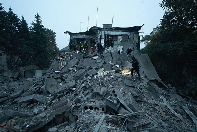 Rescue workers clear the rubble of a residential building destroyed by a Russian airstrike in Zaporizhzhia, Ukraine, Saturday, Oct. 10, 2026.