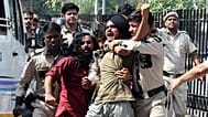Policemen detain protesters during a youth demonstration demanding the resignation of the country's election chief Gyanesh Kumar, in New Delhi, India, Saturday, Oct. 10, 2026.