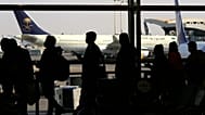 FILE - Passengers line up to check in for their flight at King Khalid Airport in Riyadh, Saudi Arabia, Monday, Jan. 11, 2021.