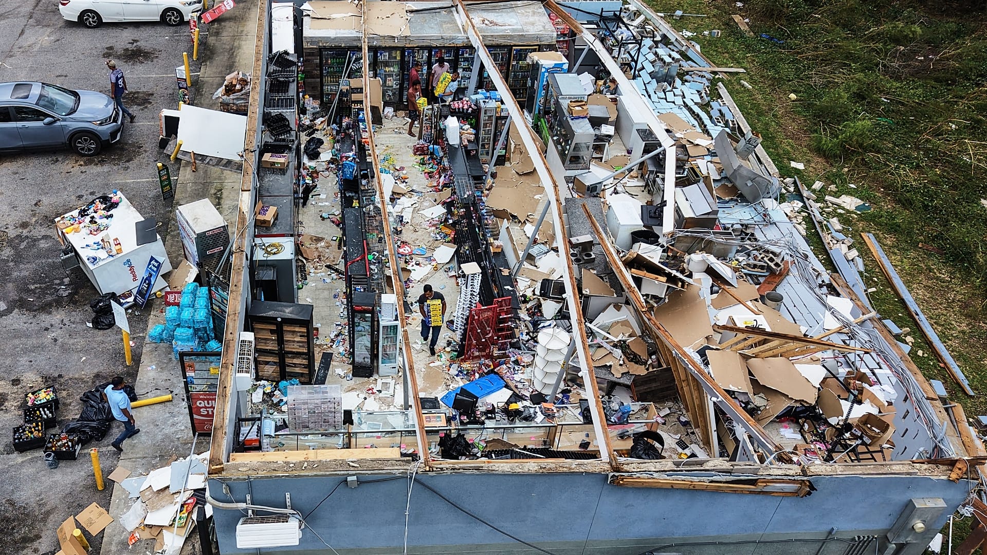 People salvage the contents of their destroyed mini mart in the aftermath of Hurricane Isaias in Milton, Fla., Saturday, Oct. 10, 2026.