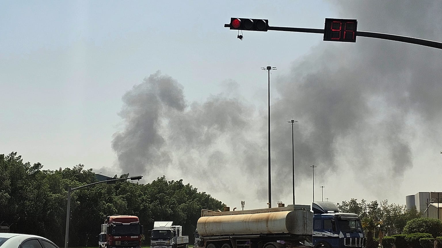 تسير المركبات على طول الطريق بينما يتصاعد الدخان الأسود من حريق في منشأة نفطية في منطقة صناعية بجنوب الرياض، المملكة العربية السعودية، السبت 3 أكتوبر 2026. (صورة AP)