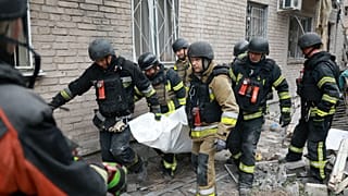 Rescue workers carry a body after pulling from the rubble of a residential building destroyed by a Russian airstrike in Zaporizhzhia.