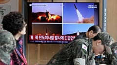 A TV screen shows file images of North Korean missiles launch during a news programme at Seoul Railway Station, 12 October, 2026