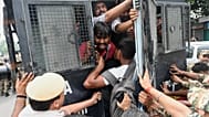 Security personnel put detained protesters into a police vehicle in New Delhi, 11 October, 2026