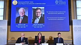 Portraits of Robert Hall and Michael Woodford on a screen at the Royal Swedish Academy of Sciences in Stockholm, 12 October, 2026