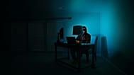 A photograph of a hacker working at their laptop, 11 July, 2019