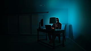 A photograph of a hacker working at their laptop, 11 July, 2019