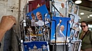Postcards of Pope Leo XIV are displayed outside a shop selling religious items near St. Peter's Square in Rome, 12 October, 2026