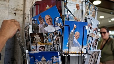 Postcards of Pope Leo XIV are displayed outside a shop selling religious items near St. Peter's Square in Rome, 12 October, 2026