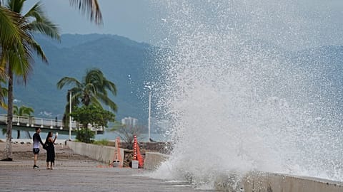 Some tourists take photos of the water crashing against the seawall as Hurricane Simon approaches Puerto Vallarta, Mexico, on 11 October 2026.
